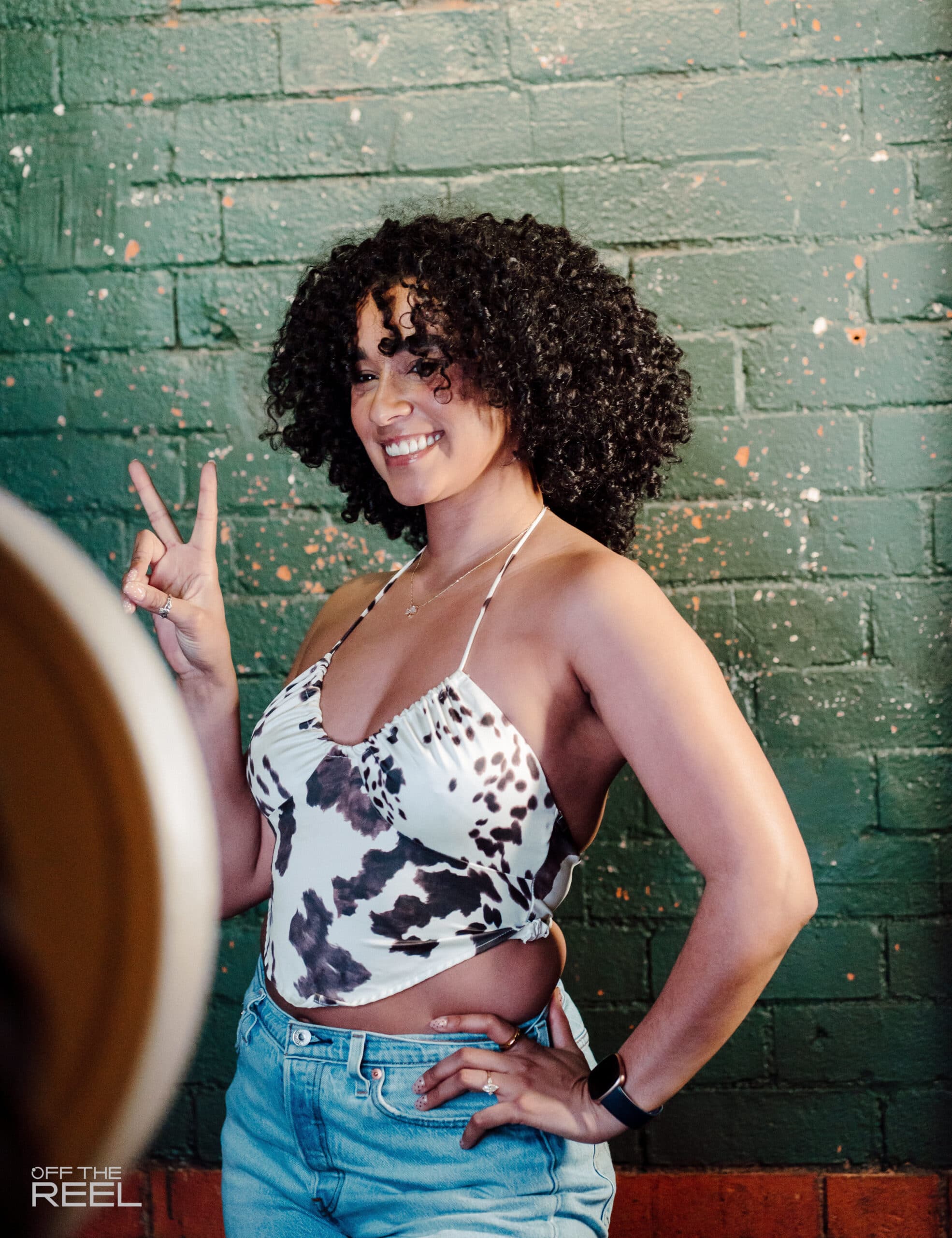 woman taking a picture at an open air photo booth