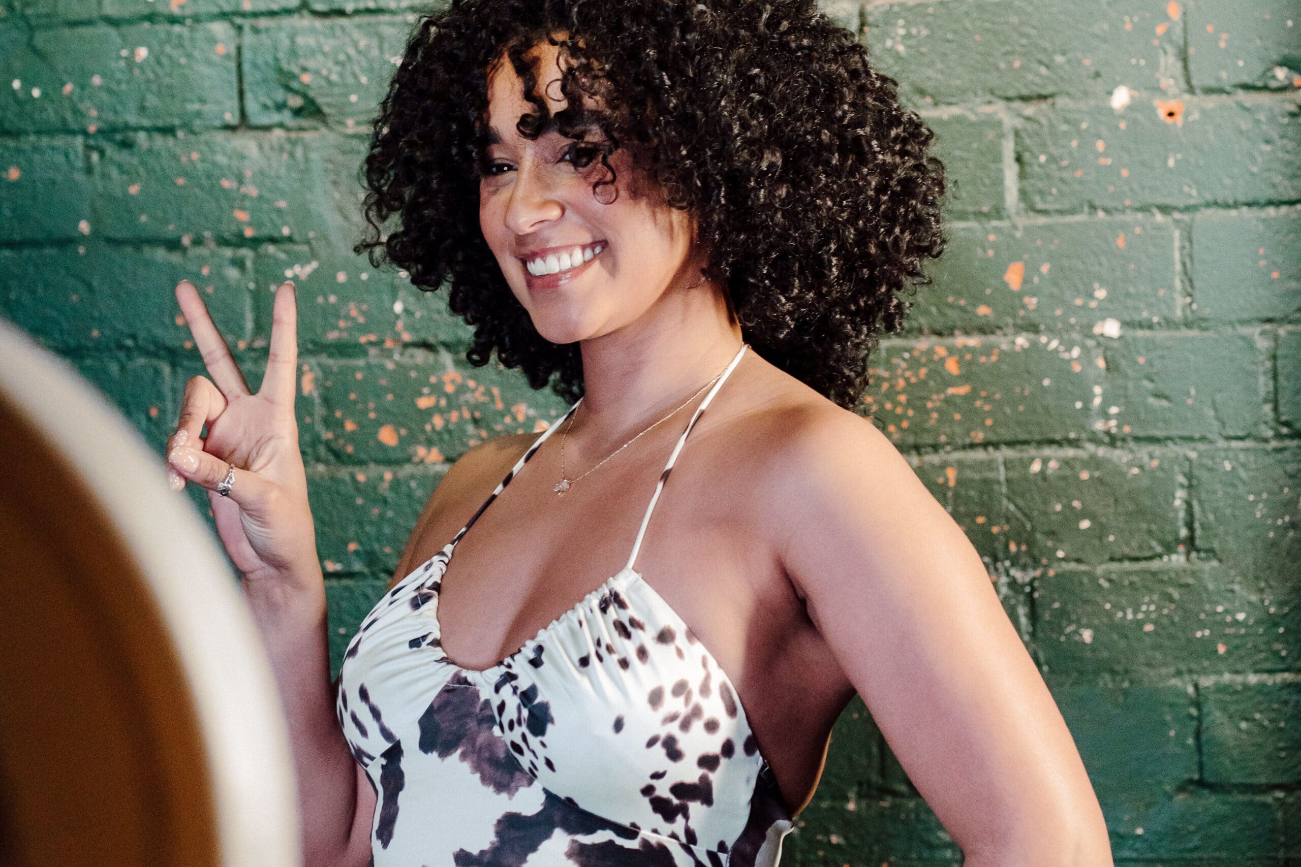 woman taking a picture at an open air photo booth